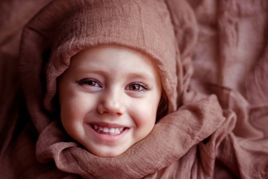 close-up portrait of a girl wrapped In Blanket