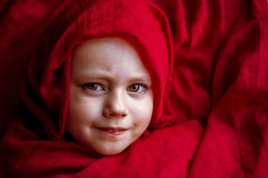 close-up portrait of a girl wrapped In Blanket