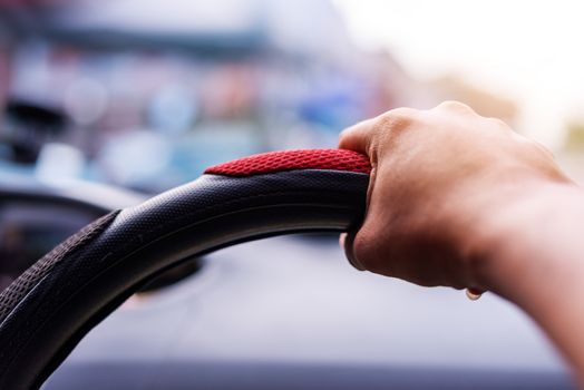 Driving concept, Hand driving a car on the road blurred background