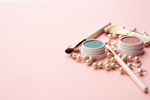 makeup brushes and eyeshadow professional cosmetics on pink background. High quality photo