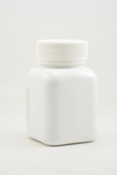 White plastic bottle container with screw cap use to put medicine tablet or capsule