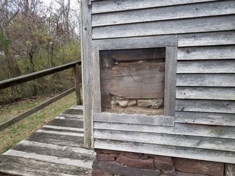 old wood house with window and stones and rocks