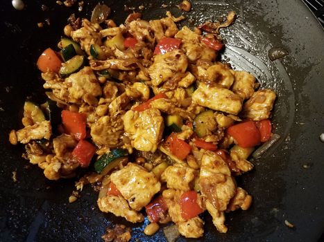 Chinese food chicken and red pepper and vegetables cooking in wok