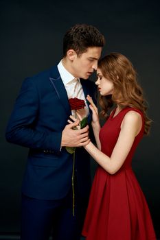 luxury couple hug romance relationship rose over dark isolated background. High quality photo