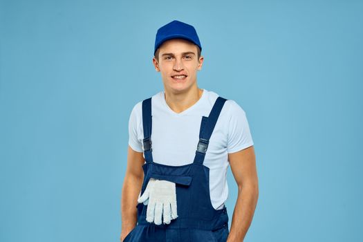 Working man in uniform of gloves loader rendering service blue background. High quality photo
