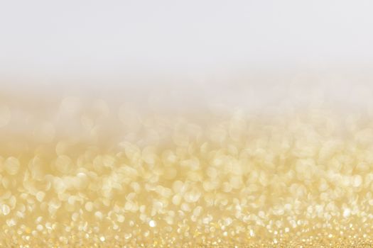 Abstract golden glitter background of shiny lights bokeh Christmas New year celebration luxury party