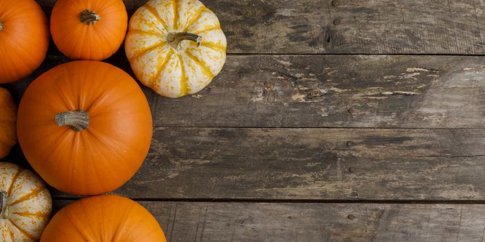 Rustic composition of pumpkins on wooden background with copy space for text, flat lay top view composition