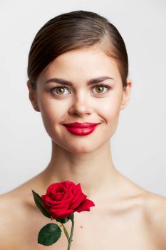 Brunette with bare shoulders Red rose luxury smile body care front view