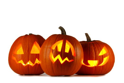 Three glowing cute Halloween Pumpkins isolated on white background