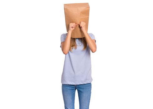 Unhappy teen girl with paper bag over head covering face with hands while crying. Upset teenager posing in studio. Child crying, not showing her tears.