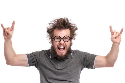 Crazy Bearded happy Man with funny Haircut in Eyeglasses making rock and roll gesture. Cheerful and silly guy, isolated on white background.