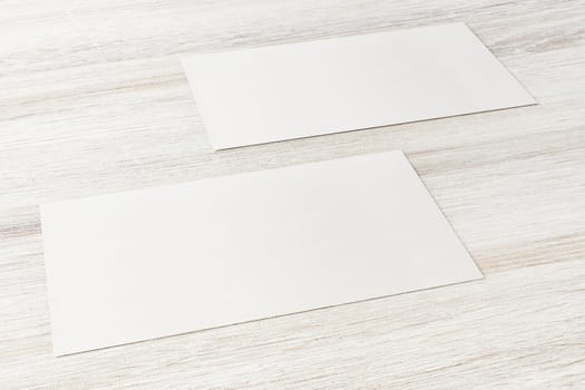 Mockup of two horizontal business cards at white textured background.