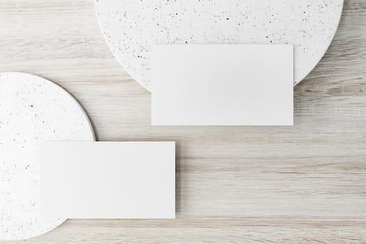 Mockup of two horizontal business cards at white textured background.