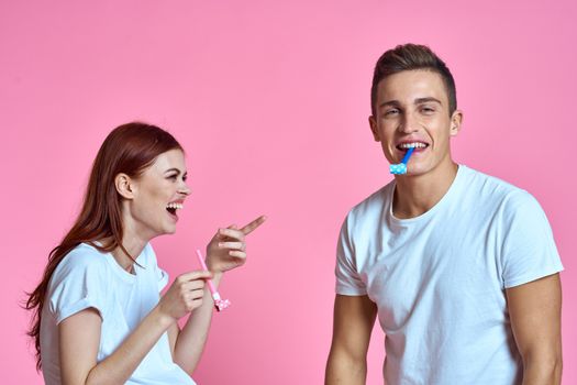 pregnant mom and happy father on pink background Young family waiting for baby. High quality photo