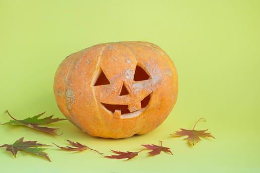 Funny pumpkin on a yellow background.The concept of Halloween.