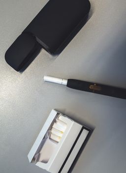 Tobacco heating system and a pack of tobacco sticks on a gray background