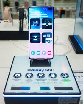 February 28, 2019 Moscow, Russia. The new smartphone from Samsung Galaxy s10+ on the shelf in the gadget store.
