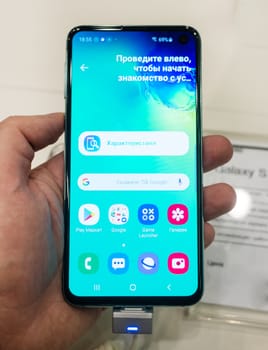 February 28, 2019 Moscow, Russia. The new smartphone from Samsung Galaxy s10e on the shelf in the gadget store.