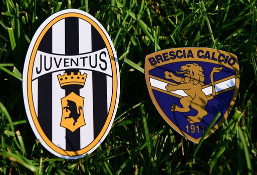 September 6, 2019, Turin, Italy. Emblems of Italian football clubs Juventus Turin and Brescia on the green grass of the lawn.