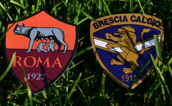 September 6, 2019, Turin, Italy. Emblems of Italian football clubs Brescia and Roma on the green grass of the lawn.