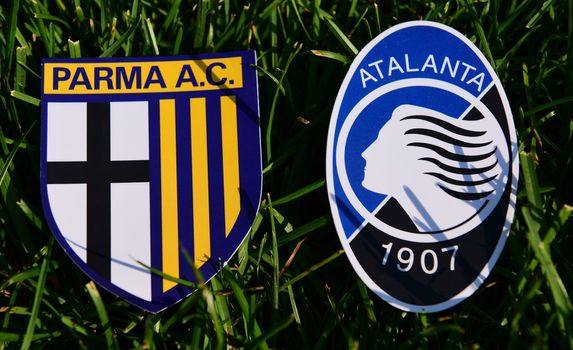 September 6, 2019, Turin, Italy. Emblems of Italian football clubs Parma and Atalanta Bergamo on the green grass of the lawn.