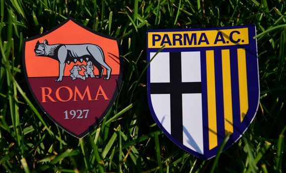 September 6, 2019, Turin, Italy. Emblems of Italian football clubs Parma and Roma on the green grass of the lawn.