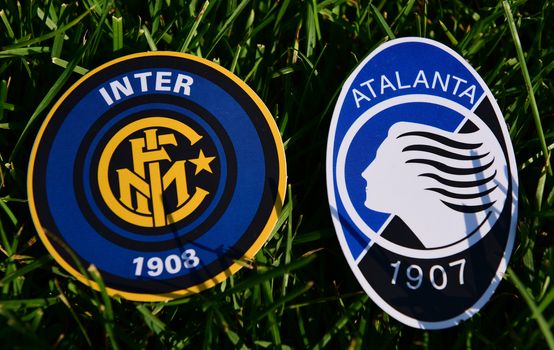 September 6, 2019, Turin, Italy. Emblems of Italian football clubs Internazionale and Atalanta Bergamo on the green grass of the lawn.