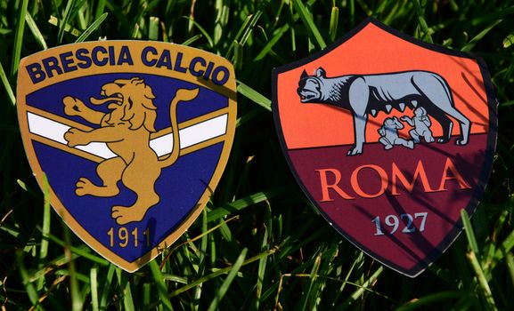 September 6, 2019, Turin, Italy. Emblems of Italian football clubs Brescia and Roma on the green grass of the lawn.