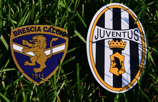 September 6, 2019, Turin, Italy. Emblems of Italian football clubs Juventus Turin and Brescia on the green grass of the lawn.
