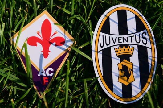 September 6, 2019, Turin, Italy. Emblems of Italian football clubs Juventus Turin and Fiorentina Florence on the green grass of the lawn.