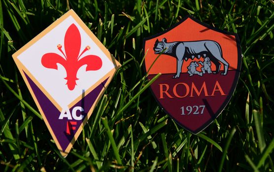 September 6, 2019, Turin, Italy. Emblems of Italian football clubs Roma and Fiorentina Florence on the green grass of the lawn.
