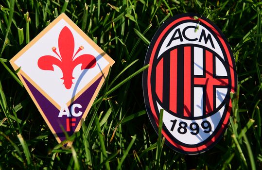 September 6, 2019, Turin, Italy. Emblems of Italian football clubs Milan and Fiorentina Florence on the green grass of the lawn.