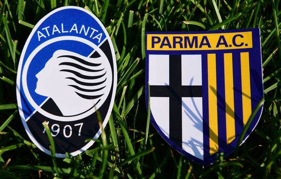 September 6, 2019, Turin, Italy. Emblems of Italian football clubs Parma and Atalanta Bergamo on the green grass of the lawn.