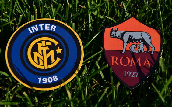 September 6, 2019, Turin, Italy. Emblems of Italian football clubs Roma and Internazionale on the green grass of the lawn.