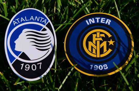 September 6, 2019, Turin, Italy. Emblems of Italian football clubs Internazionale and Atalanta Bergamo on the green grass of the lawn.