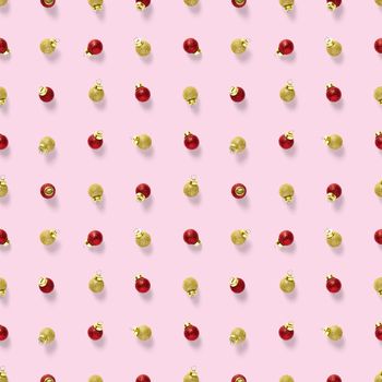 Seamless pattern with red and gold Christmas decorations on pink background. Christmas red ornaments Seamless pattern. Christmas abstract background made from balls.