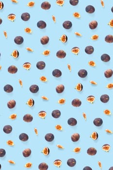 Background from Fresh figs. Food Photo. Modern fig fruits background. Creative set of the whole and sliced figs on a blue background, not pattern