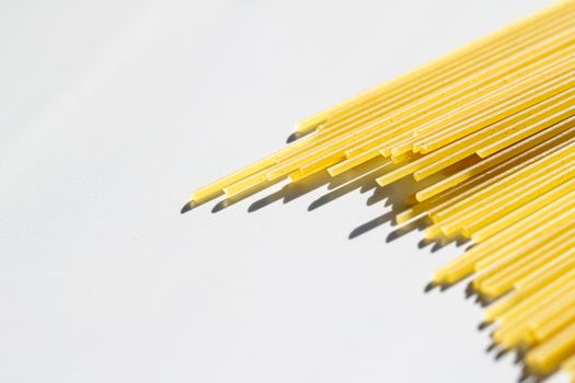 Uncooked whole grain spaghetti closeup, italian pasta as organic food ingredient, macro product and cook book recipes