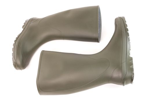 A pair of clean green rubber boots laying down isolated on white background. Front view.