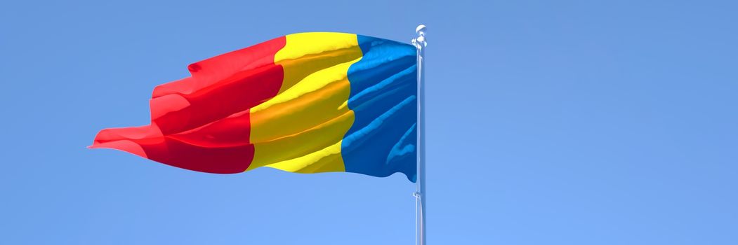 3D rendering of the national flag of Chad waving in the wind against a blue sky