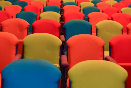 Bright colored chairs in a row forming a pattern