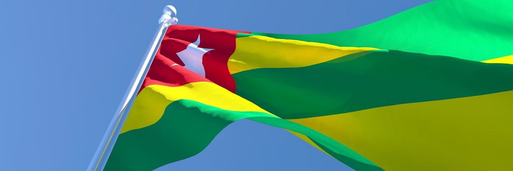 3D rendering of the national flag of Togo waving in the wind against a blue sky