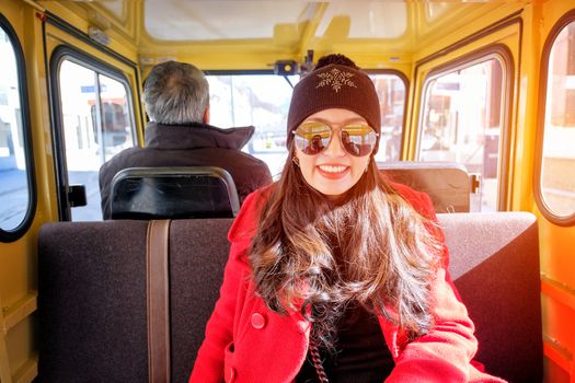 Close up portrait of happy tourist young asian woman sitting in yellow Taxi car 
