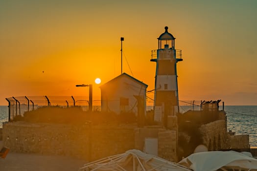 Sunset view of the lighthouse, in the old city of Acre (Akko), Israel