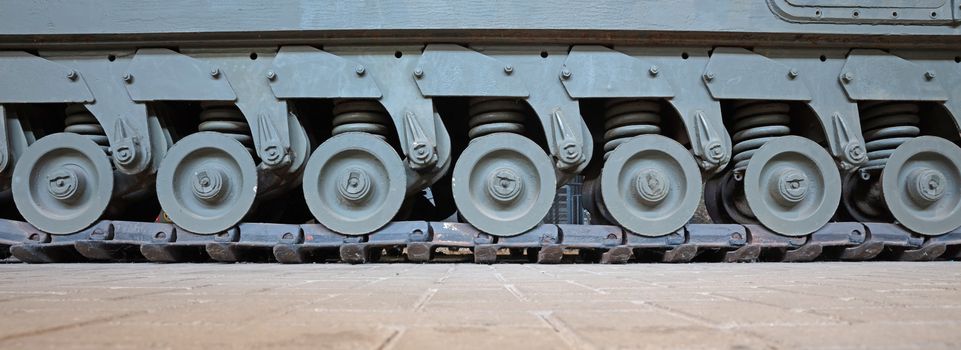 Tracks and wheels of tank, armored vehicle, old tank