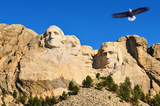 Mount Rushmore in South Dakota, U.S.A. with a bald eagle flying over in the background.