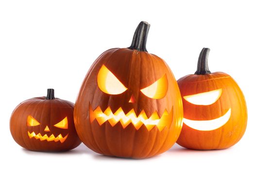 Three glowing cute Halloween Pumpkins isolated on white background