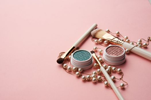 eyeshadow accessories beads makeup brushes collection professional cosmetics on pink background. High quality photo