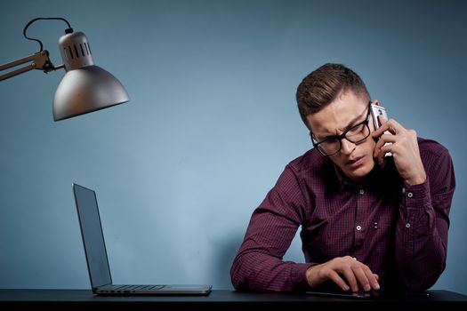 Business man talking on the phone in the office open laptop manager communication model. High quality photo