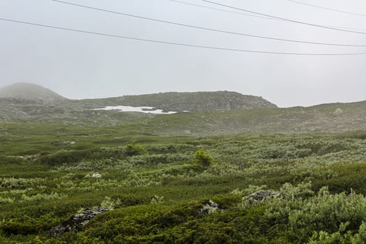 Fog, clouds, rocks and cliffs on Veslehødn Veslehorn mountain in Hemsedal, Norway.